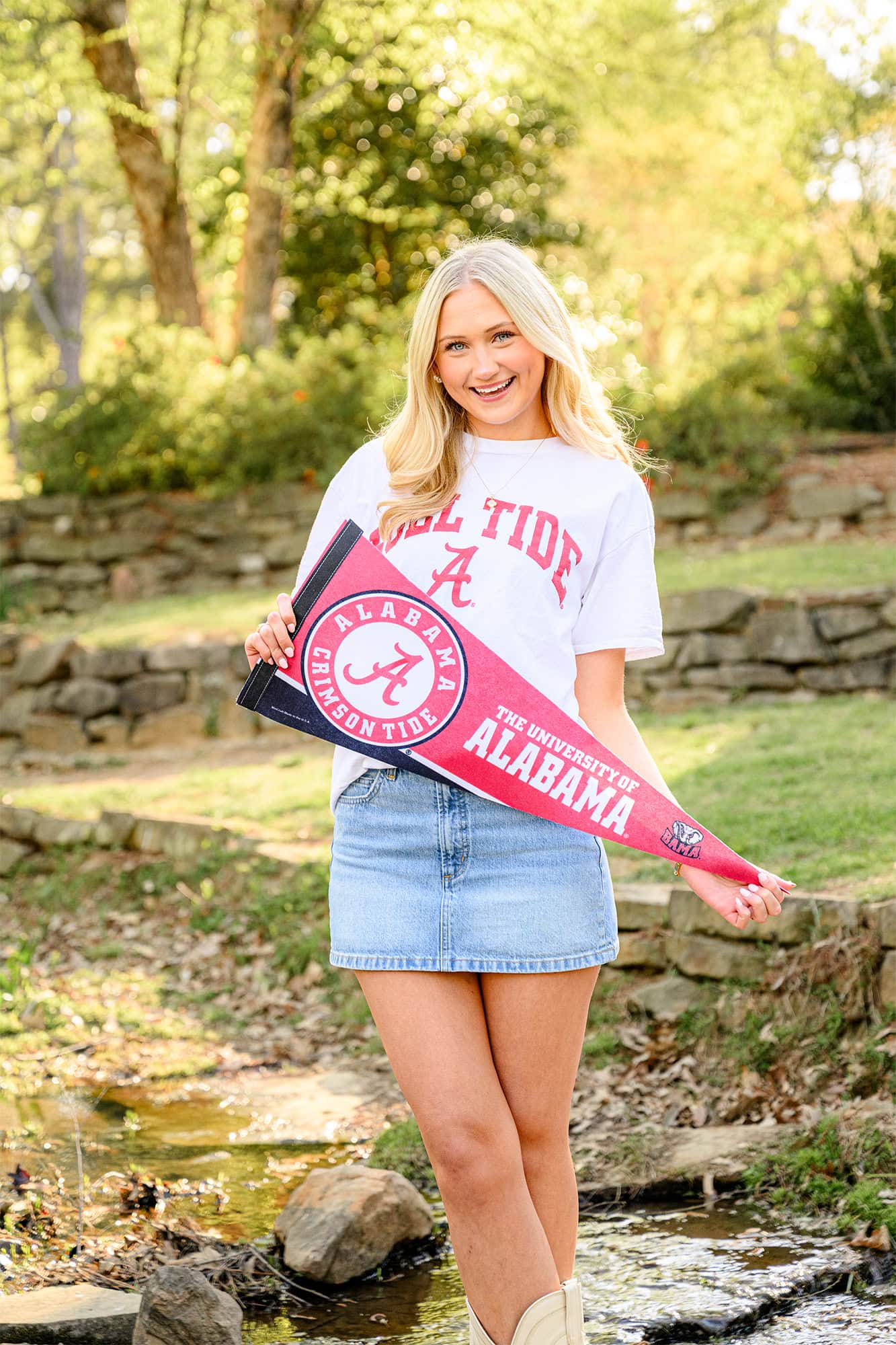 charlotte catholic grad holding university of alabama pennant and wearing a t shirt