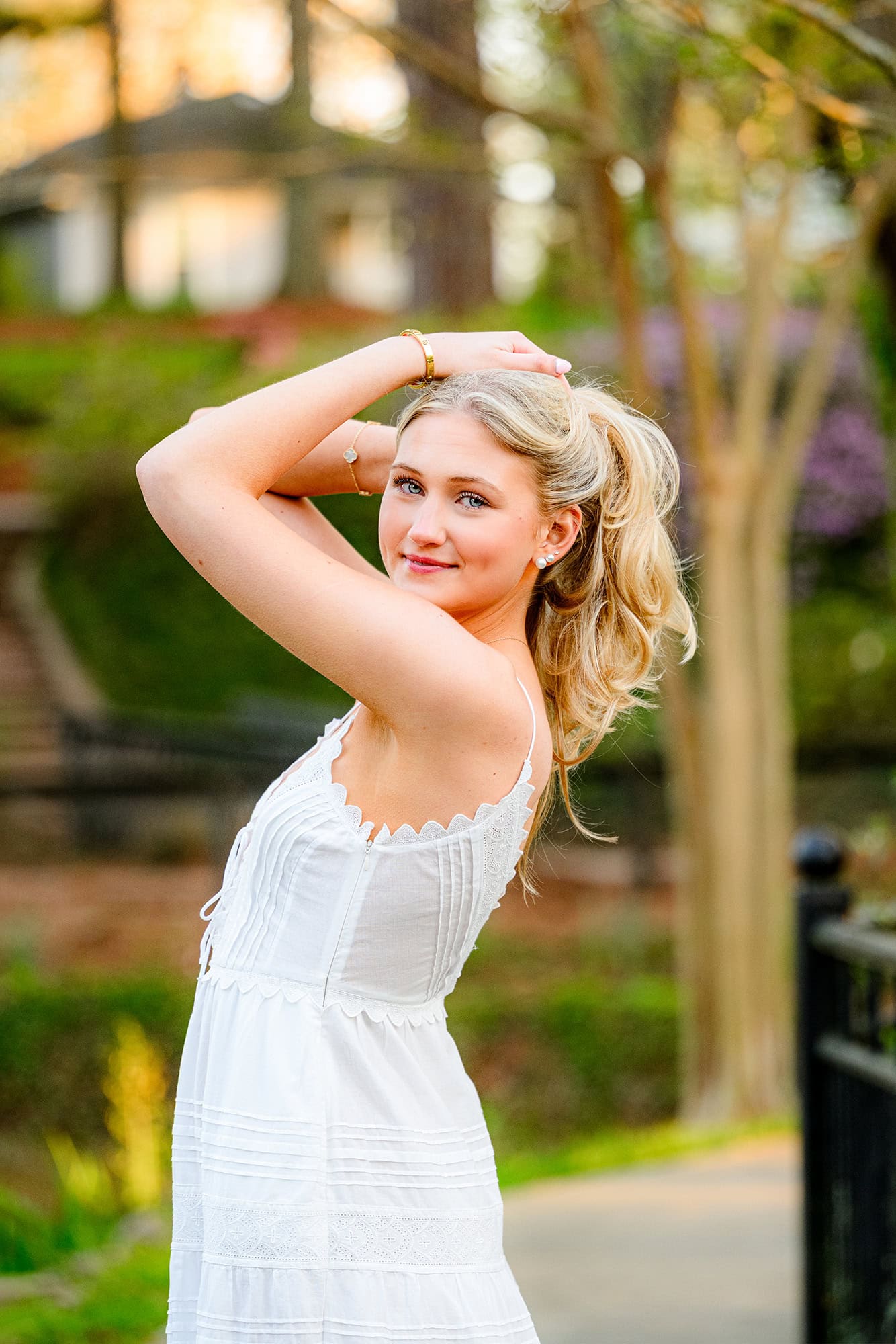 blonde charlotte catholic grad poses with hair pulled up for senior photos