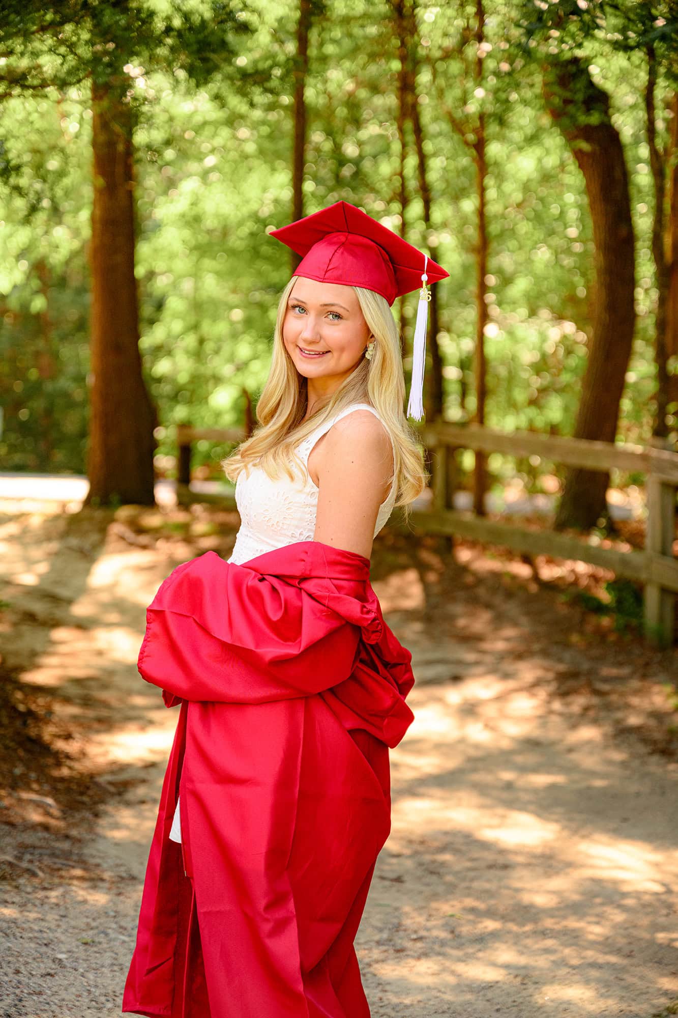 blonde senior charlotte catholic grad wearing cap and gown