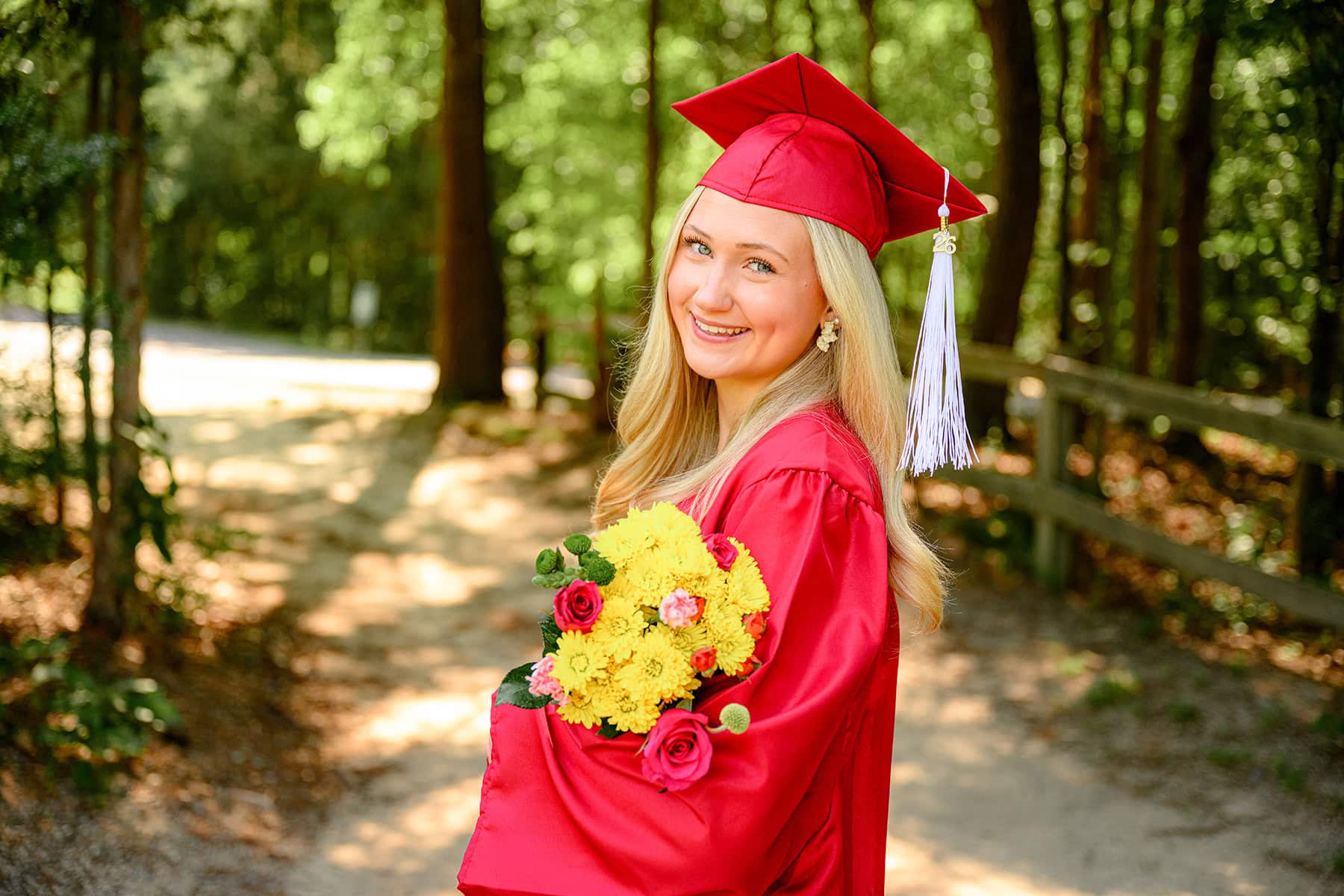 red charlotte catholic graduation cap and gown photo with blonde senior
