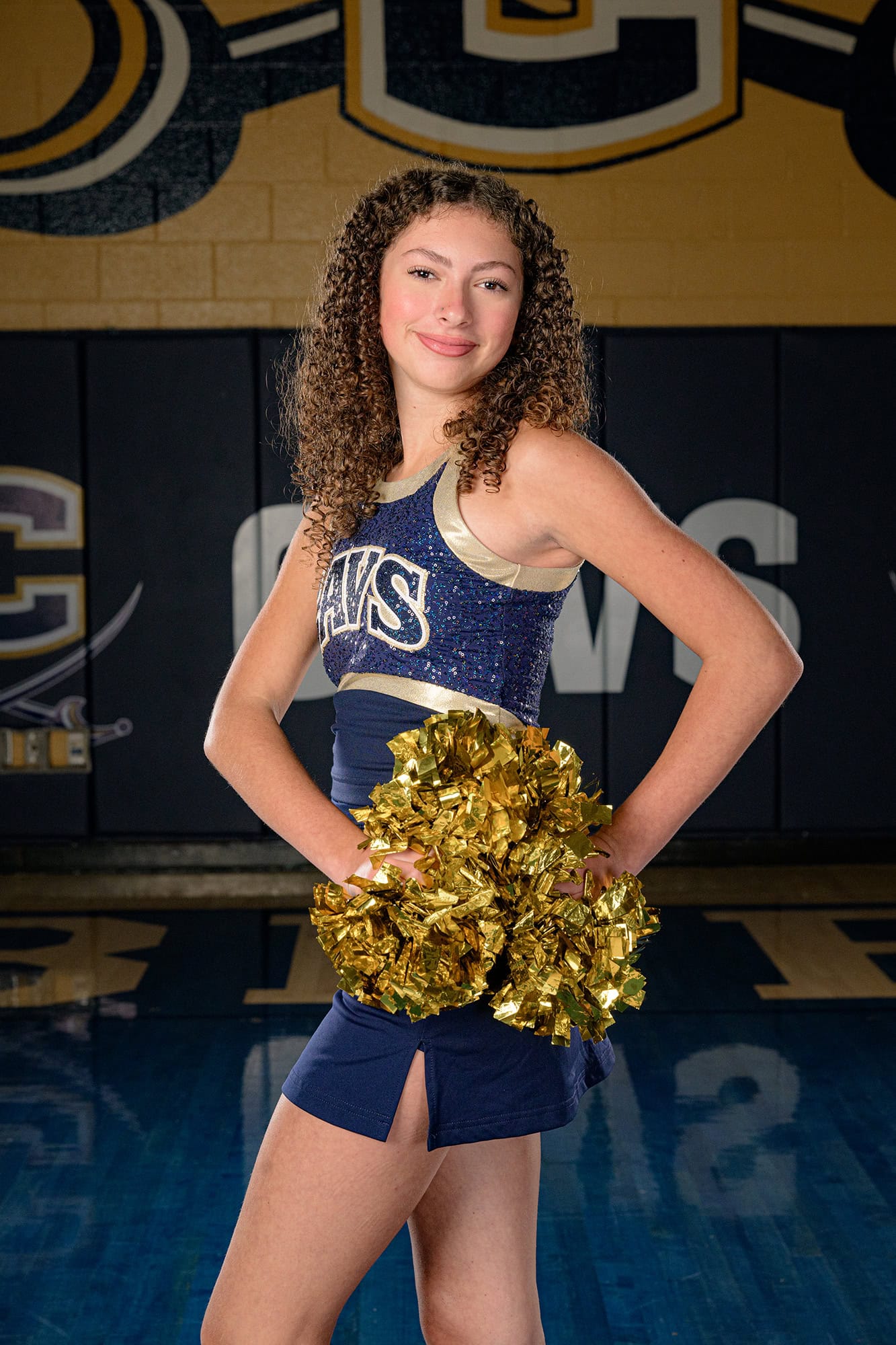 dancer with hands on hip on home court