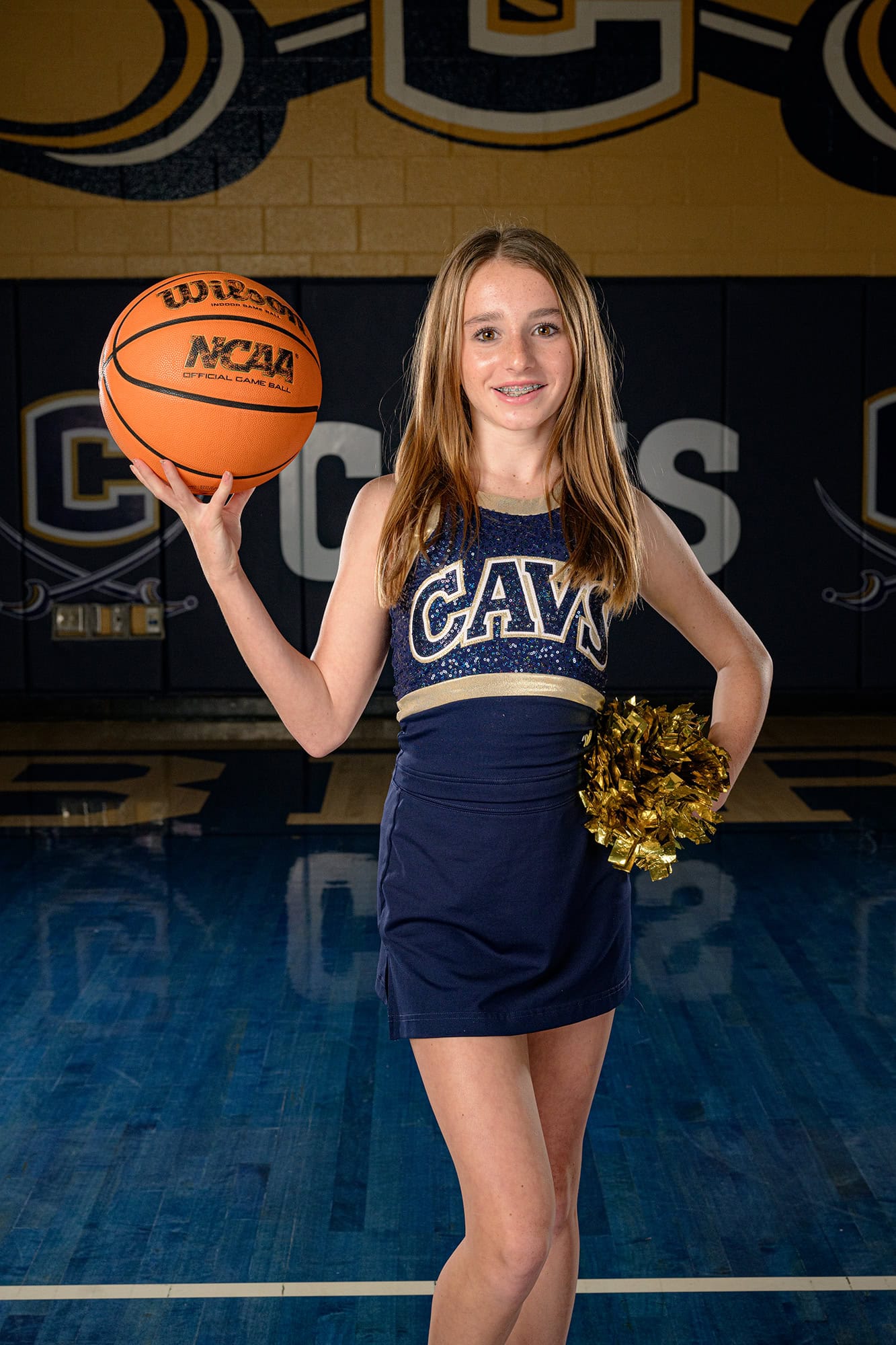CHS Dance team media day photo of freshman dancer holding pom and basketball