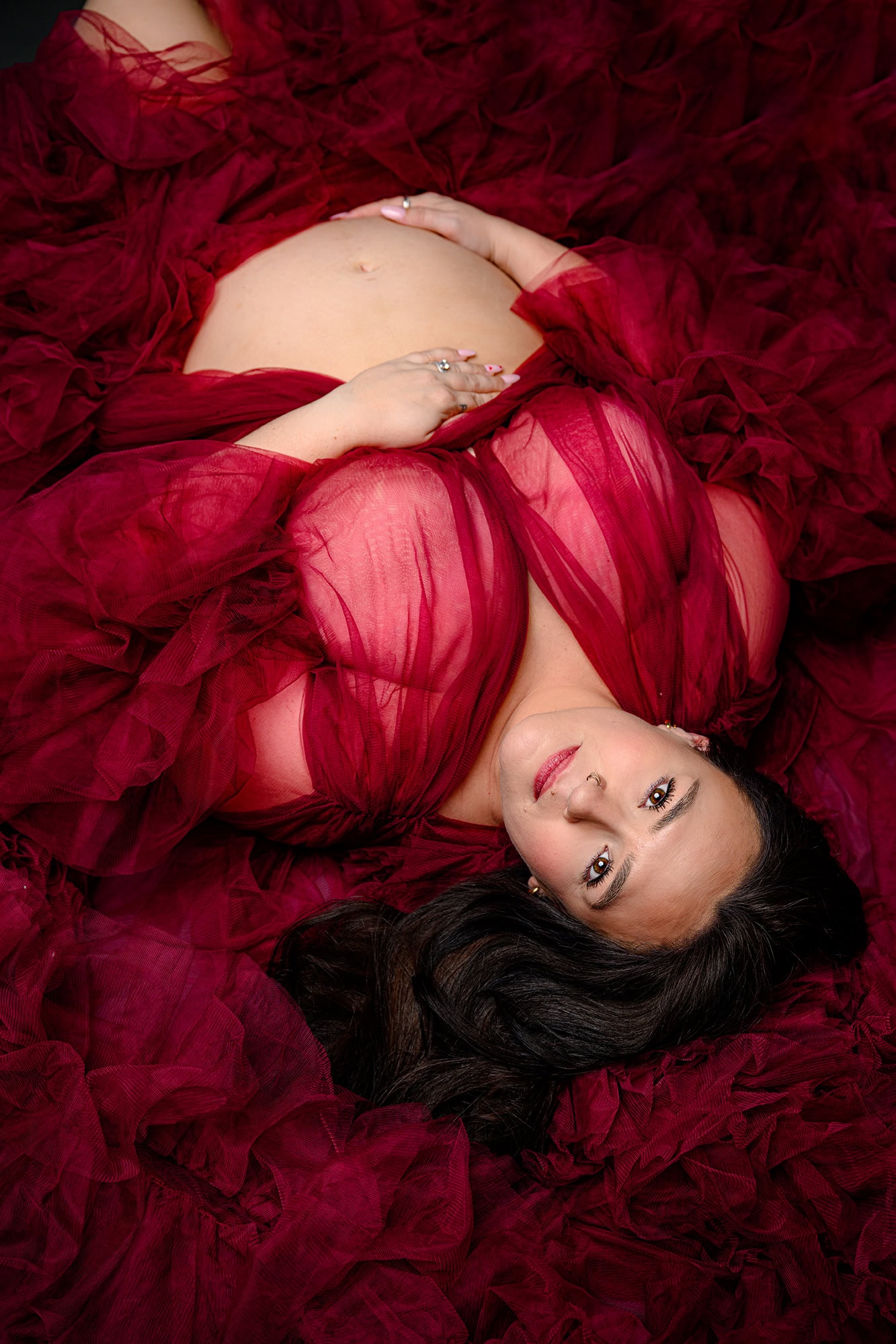 charlotte area pregnant mom laying down with her belly exposed